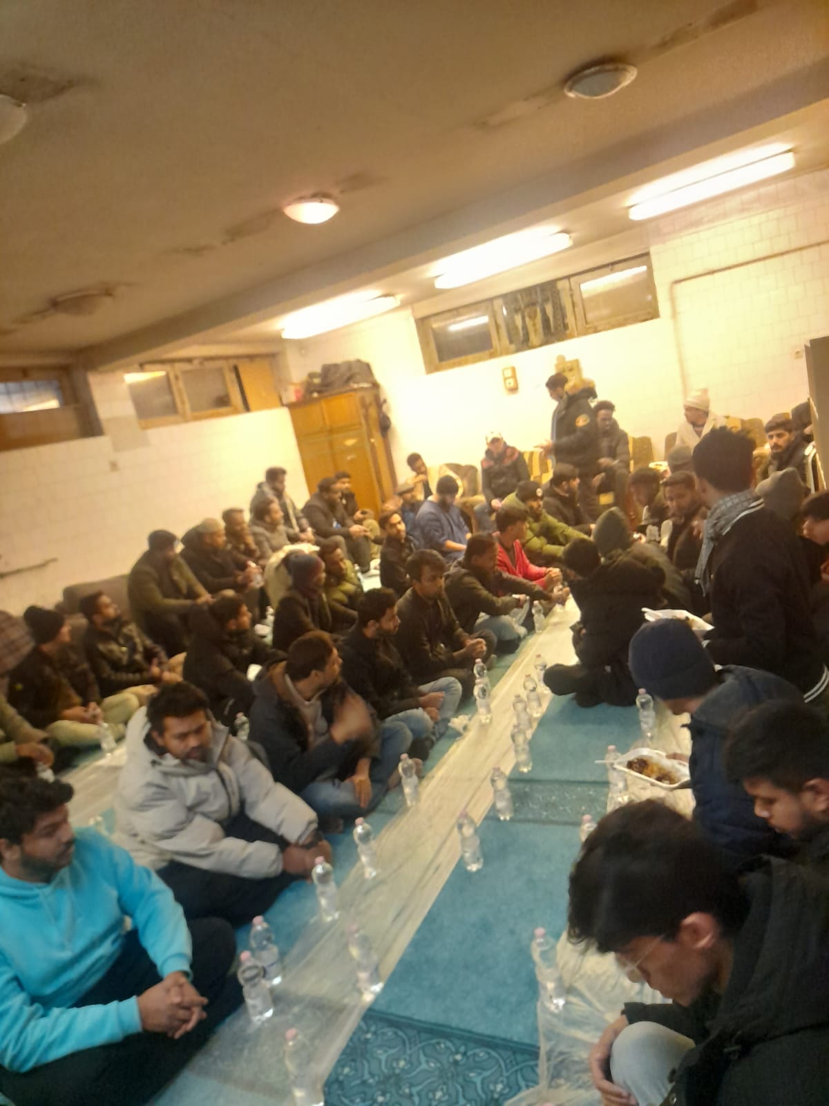 Community meal setup inside Masjid Al Noor
